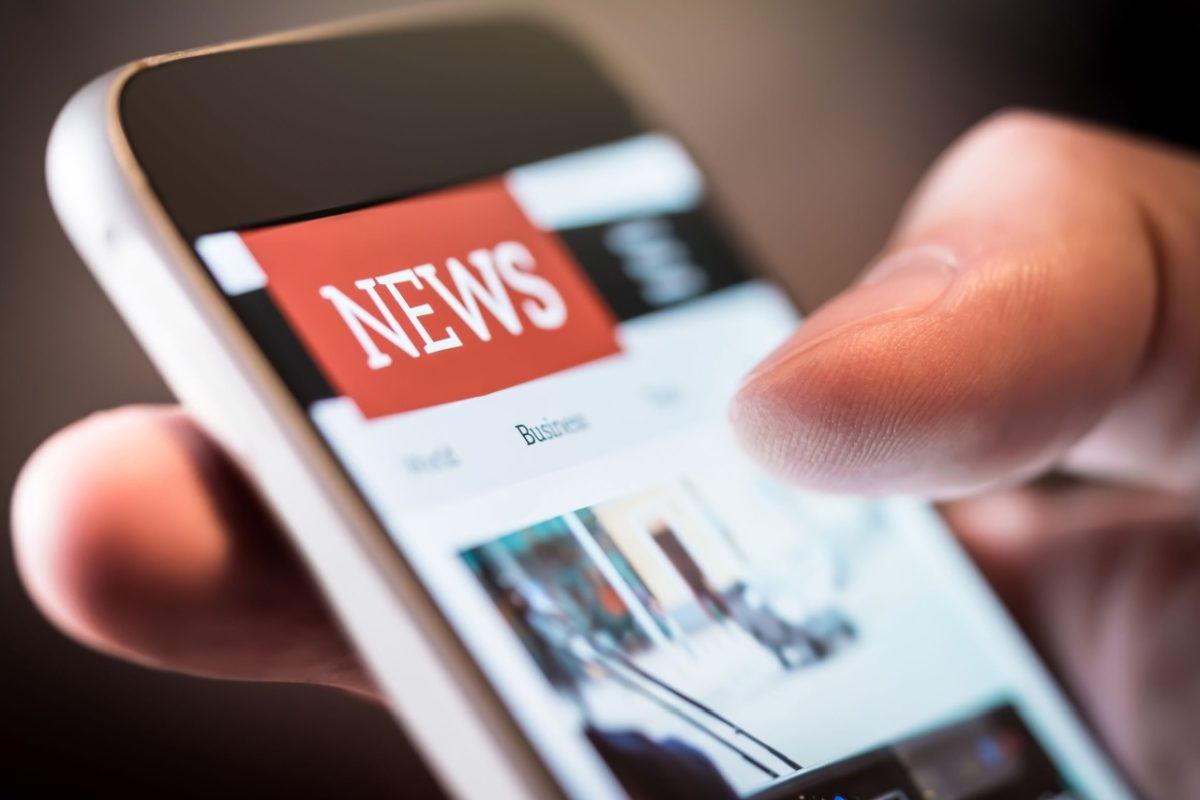 A person using a smartphone to read the news.