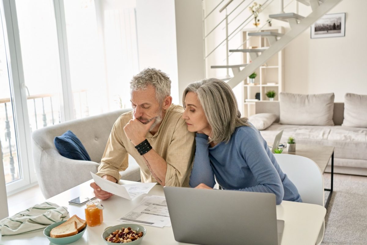 A couple looking at paperwork together in their home.